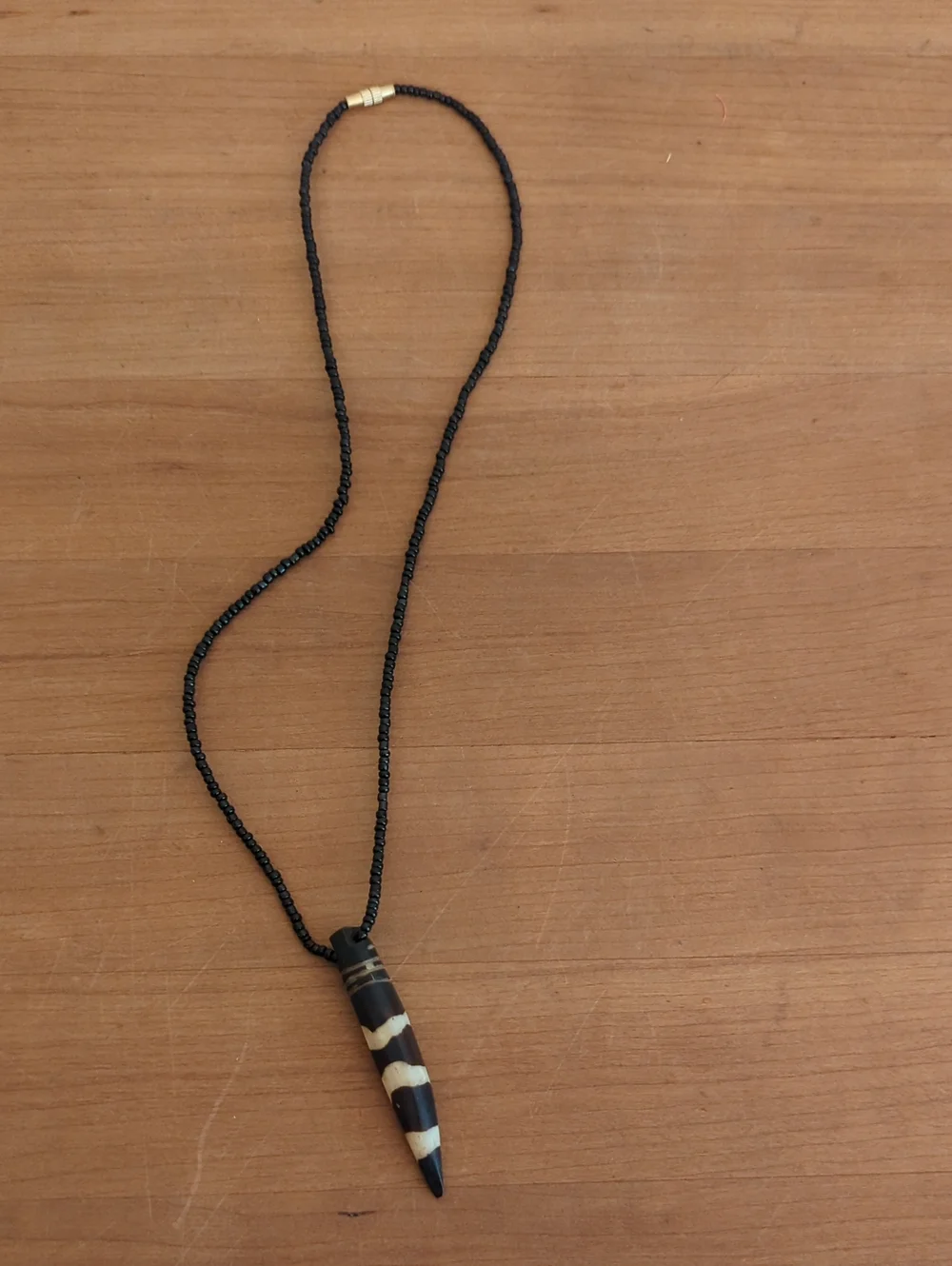 Handcrafted Black Beaded Pendant Necklace with Striped Horn Charm